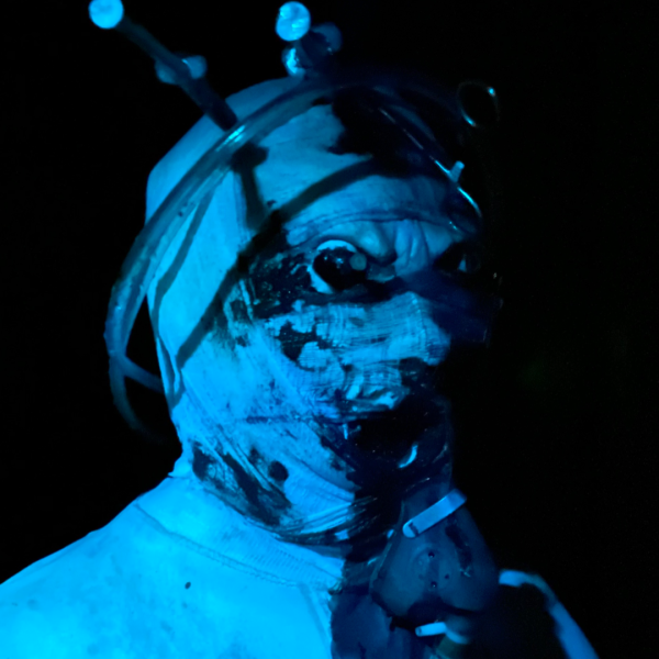 a person wearing a blue light in a dark room