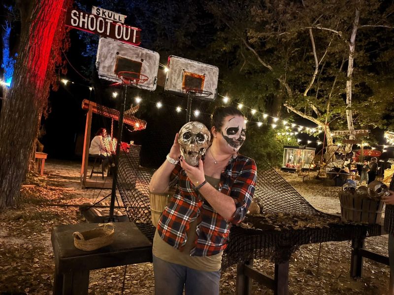 Skull Shootout booth with two basketball hoops and a skull-painted actor