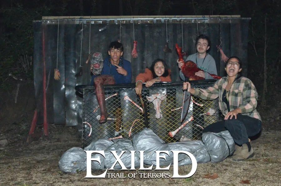 Friends posing with Halloween props at Exiled on Saturday night